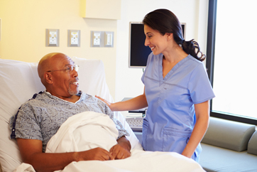 African American Man in Hospital Talking with Doctor