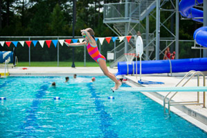 little girl diving into a pool